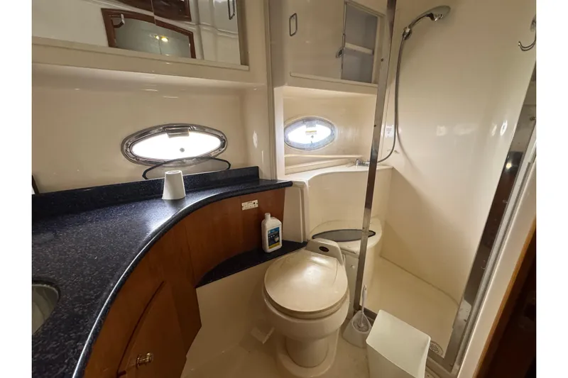  Yacht Photos Pics 2002 Carver 466 Motor Yacht bathroom with shower, toilet, and countertop.