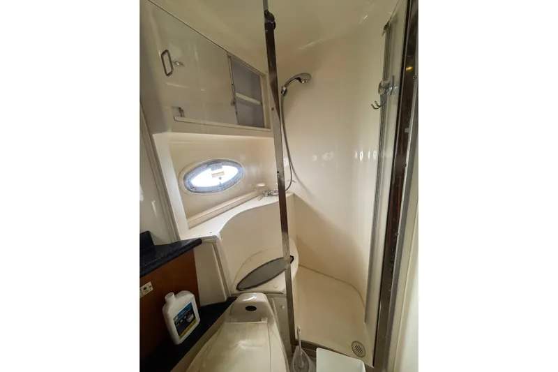  Yacht Photos Pics Bathroom interior of 2002 Carver 466 Motor Yacht with shower and porthole window.