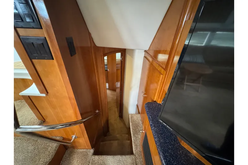  Yacht Photos Pics Interior view of 2002 Carver 466 Motor Yacht, featuring wooden stairs and cabinetry.