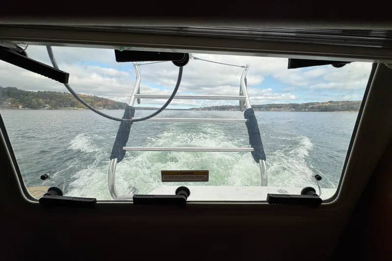  Yacht Photos Pics View from 2002 Carver 466 Motor Yacht window, showing wake and distant shoreline.