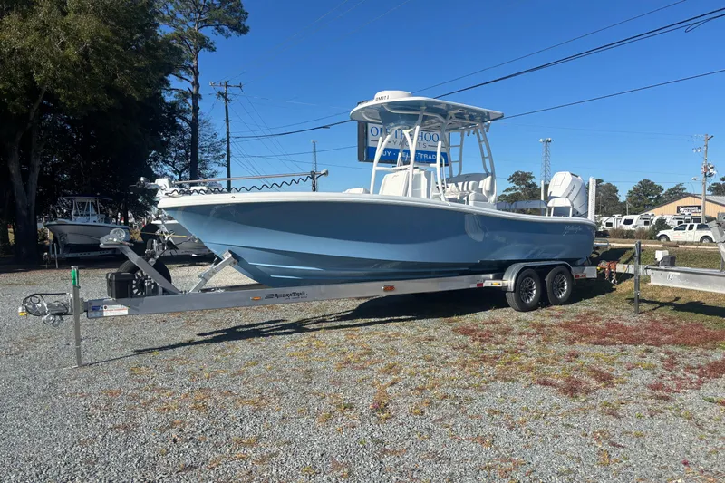  Yacht Photos Pics 2026 Yellowfin 26 Hybrid boat on trailer, parked outdoors under clear blue sky.