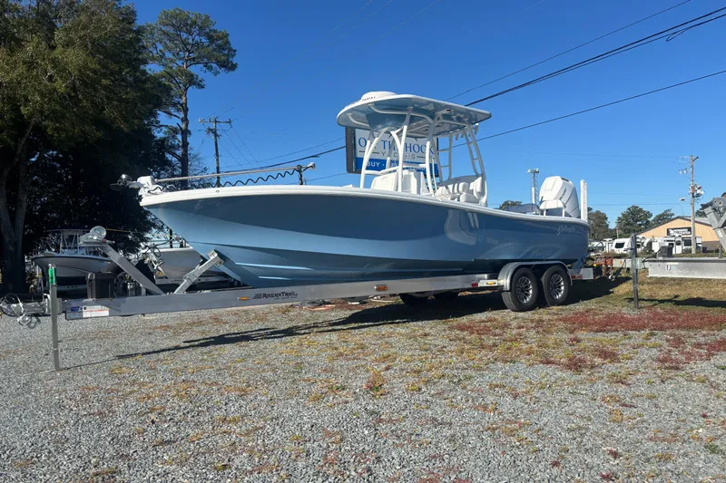  Yacht Photos Pics 2026 Yellowfin 26 Hybrid boat on trailer, parked outdoors under clear blue sky.