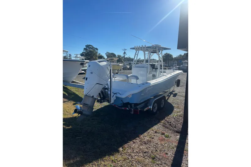  Yacht Photos Pics 2026 Yellowfin 26 Hybrid boat on trailer, parked outdoors under clear sky.