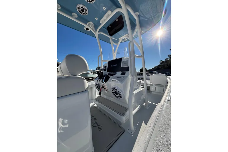  Yacht Photos Pics 2026 Yellowfin 26 Hybrid boat interior with Garmin electronics under a sunny sky.