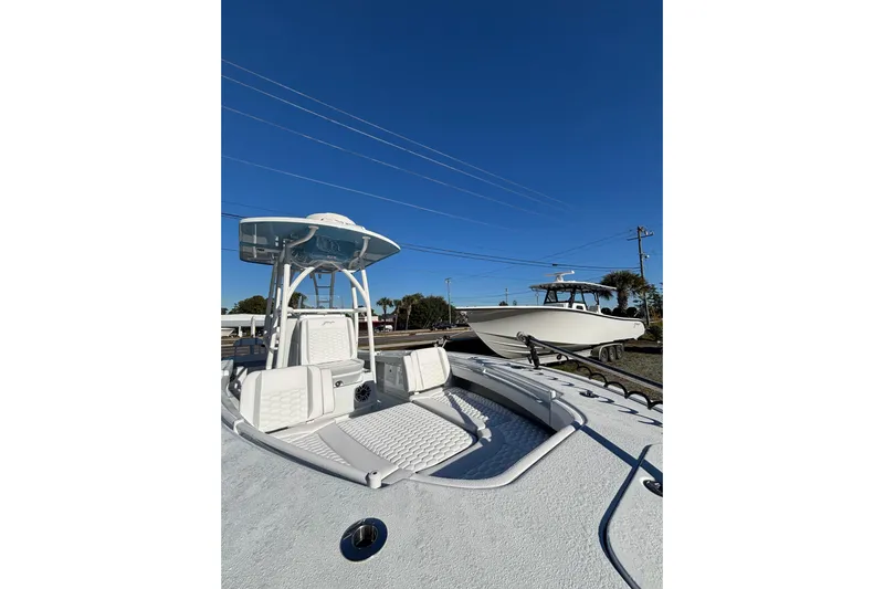  Yacht Photos Pics 2026 Yellowfin 26 Hybrid boat with sleek design under clear blue sky.