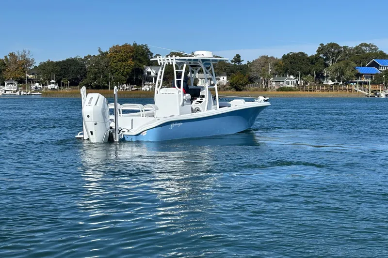  Yacht Photos Pics 2026 Yellowfin 26 Hybrid boat cruising on a calm lake with scenic background.