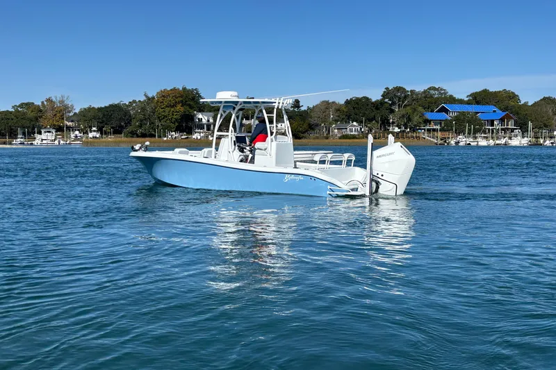  Yacht Photos Pics 2026 Yellowfin 26 Hybrid boat cruising on a calm blue lake under clear skies.