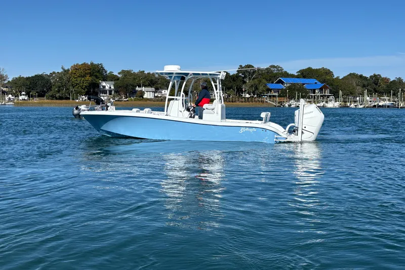  Yacht Photos Pics 2026 Yellowfin 26 Hybrid boat cruising on a calm blue lake.