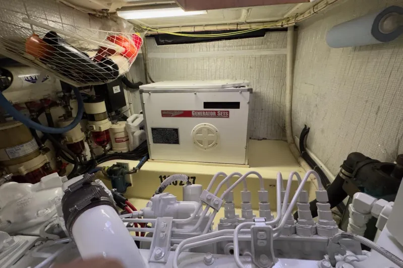 Leto Yacht Photos Pics Engine room of a 2001 American Tug 34 with generator and mechanical components.