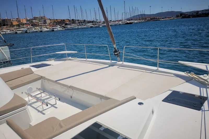 Eagle Yacht Photos Pics 2022 Bali 4.8 yacht deck with seating, docked in a marina under clear skies.