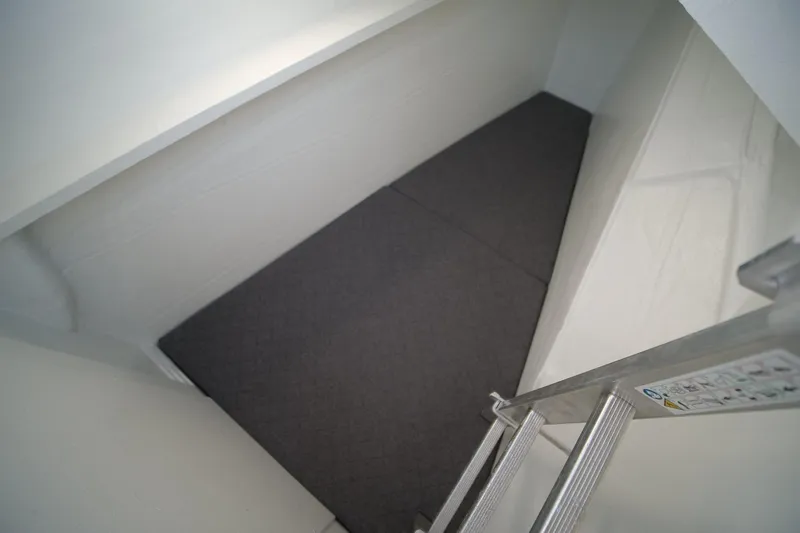 Eagle Yacht Photos Pics Interior view of 2022 Bali 4.8 yacht cabin with ladder and cushioned floor.