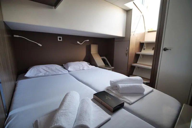 Eagle Yacht Photos Pics Luxurious cabin interior of 2022 Bali 4.8 yacht with neatly arranged towels and book.
