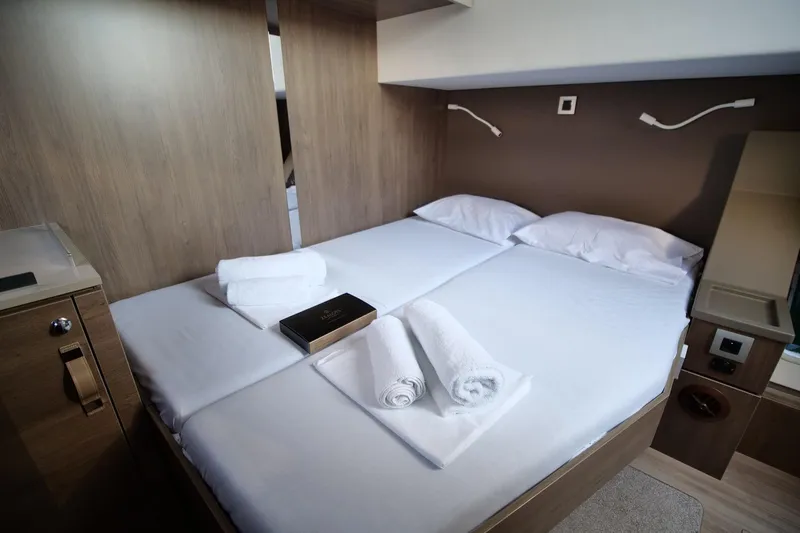Eagle Yacht Photos Pics Luxurious 2022 Bali 4.8 yacht cabin with neatly arranged bed and towels.