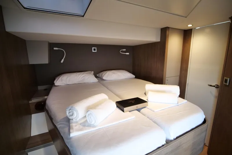 Eagle Yacht Photos Pics Luxurious cabin interior of 2022 Bali 4.8 yacht with twin beds and modern decor.