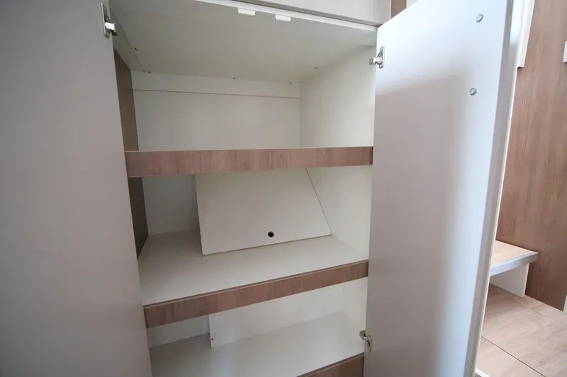 Eagle Yacht Photos Pics Open cabinet with wooden shelves in a Bali 4.8 model, 2022.