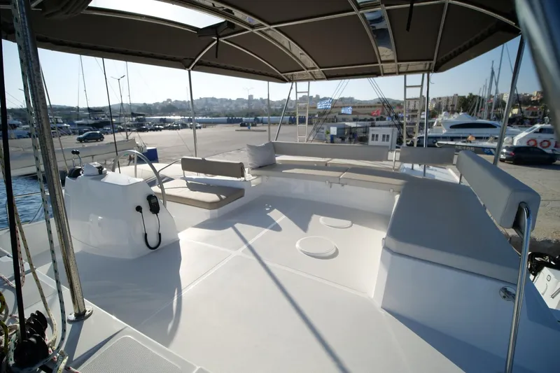 Eagle Yacht Photos Pics 2022 Bali 4.8 yacht deck with seating area and canopy in marina setting.