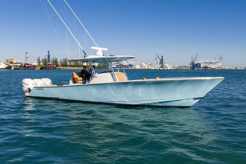 Wahoo Whitney Yacht Photos Pics 2022 Valhalla Boatworks V-37 cruising on blue water near an industrial port.