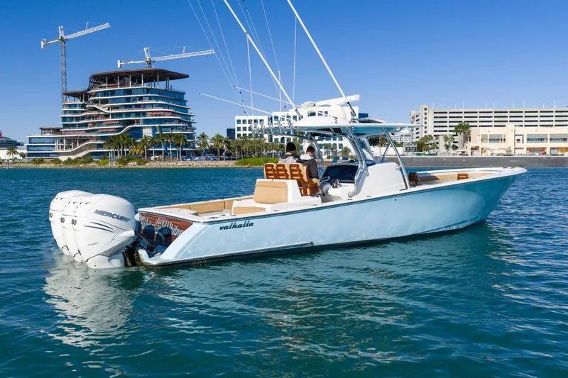 Wahoo Whitney Yacht Photos Pics 2022 Valhalla Boatworks V-37 on water, modern buildings in background.