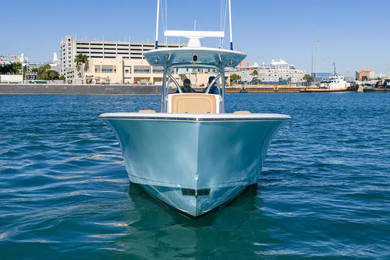 Wahoo Whitney Yacht Photos Pics 2022 Valhalla Boatworks V-37 on water, cityscape background, clear blue sky.