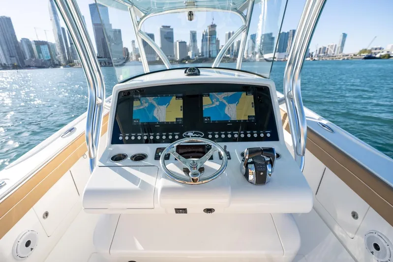 Wahoo Whitney Yacht Photos Pics 2022 Valhalla Boatworks V-37 helm with dual navigation screens, city skyline in background.