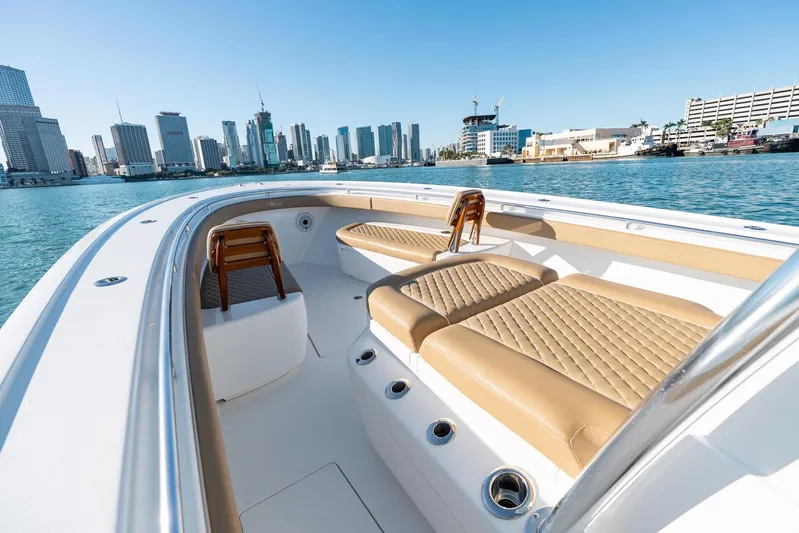 Wahoo Whitney Yacht Photos Pics 2022 Valhalla Boatworks V-37 with luxurious seating, city skyline in background.