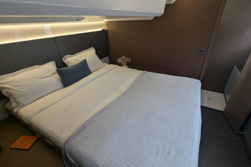  Yacht Photos Pics Luxurious bedroom interior of 2024 Prestige M48 yacht with elegant bedding and modern design.