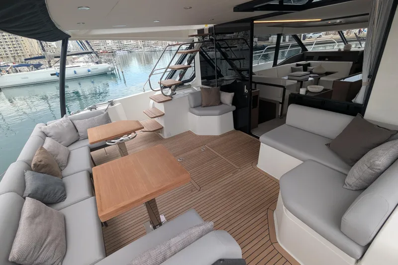  Yacht Photos Pics Luxurious 2024 Prestige M48 yacht interior with elegant seating and wooden tables.