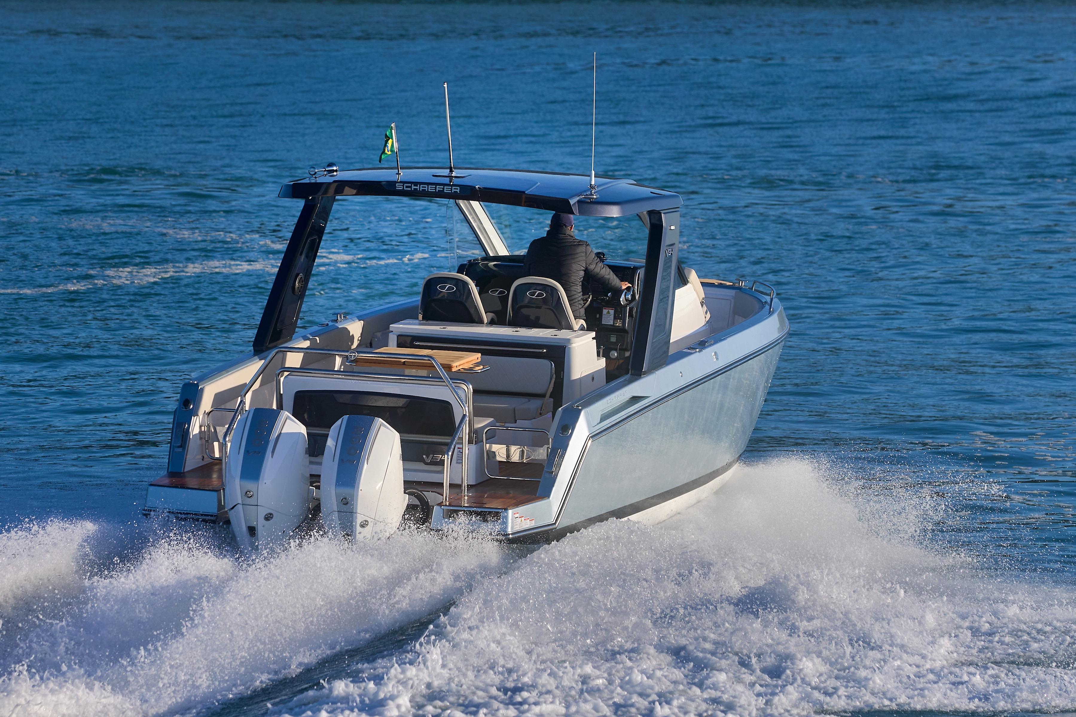 2026 Schaefer V34 boat cruising on open water, rear view.