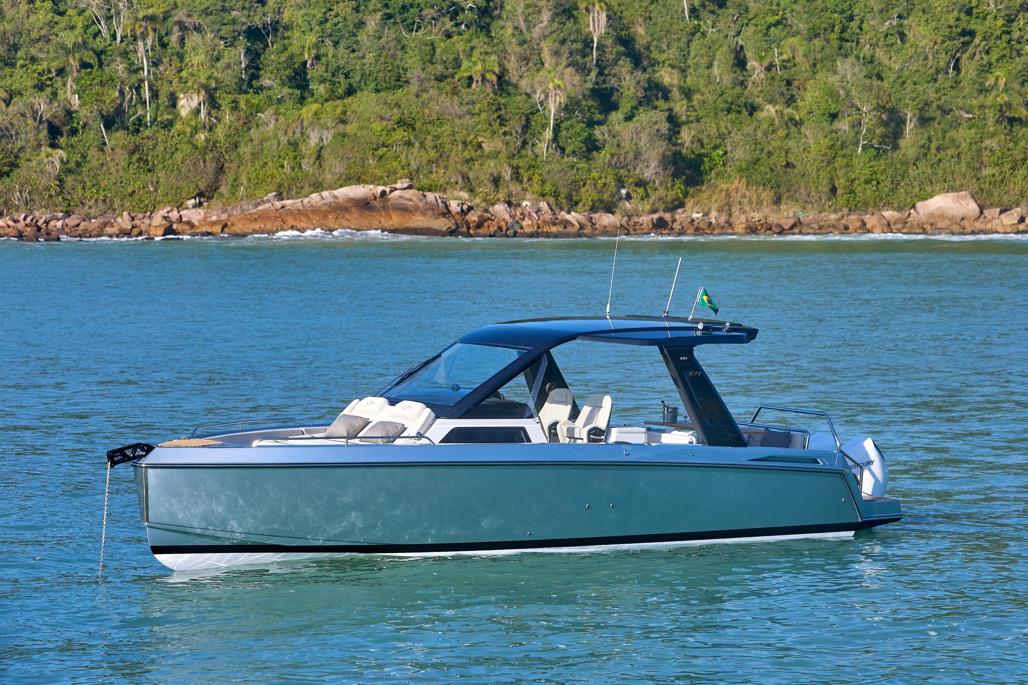 2026 Schaefer V34 yacht on calm water with lush green shoreline.