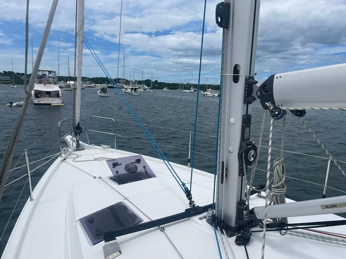 Shaz Yacht Photos Pics Jeanneau Sun Odyssey 410 sailboat deck, 2020 model, anchored in a marina with cloudy skies.