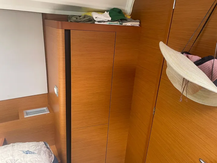 Shaz Yacht Photos Pics Interior of 2020 Jeanneau Sun Odyssey 410 with wooden cabinetry and hanging hat.