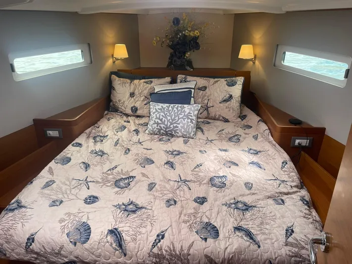 Shaz Yacht Photos Pics Luxurious cabin interior of 2020 Jeanneau Sun Odyssey 410 with nautical-themed bedding.