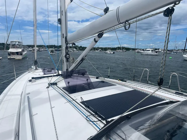 Shaz Yacht Photos Pics 2020 Jeanneau Sun Odyssey 410 sailboat on a calm marina with other boats.