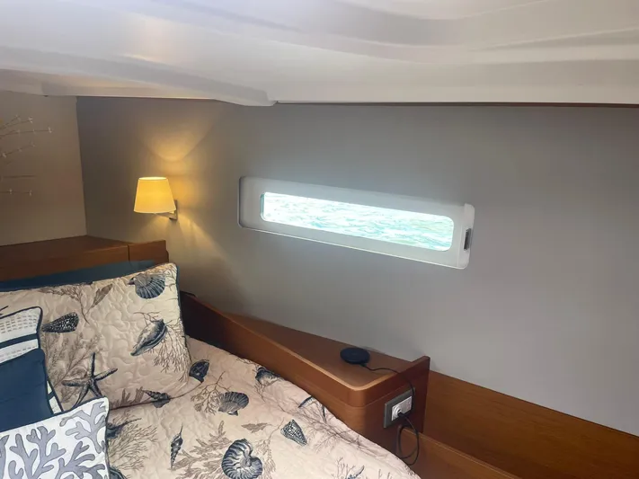 Shaz Yacht Photos Pics Cozy cabin interior of 2020 Jeanneau Sun Odyssey 410 with nautical-themed bedding.