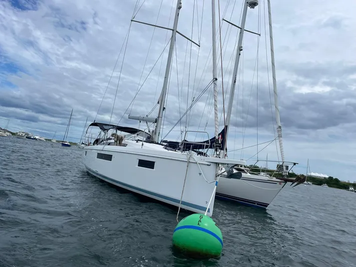 Shaz Yacht Photos Pics 2020 Jeanneau Sun Odyssey 410 sailboat anchored on a cloudy day.