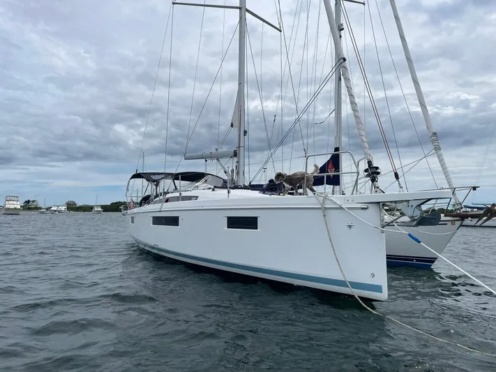 Shaz Yacht Photos Pics 2020 Jeanneau Sun Odyssey 410 sailboat anchored on a cloudy day.