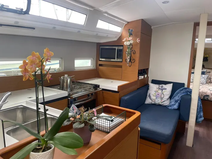 Shaz Yacht Photos Pics Interior of 2020 Jeanneau Sun Odyssey 410 yacht with kitchen and seating area.