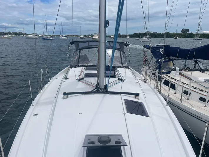 Shaz Yacht Photos Pics 2020 Jeanneau Sun Odyssey 410 sailboat docked in a marina with other boats.