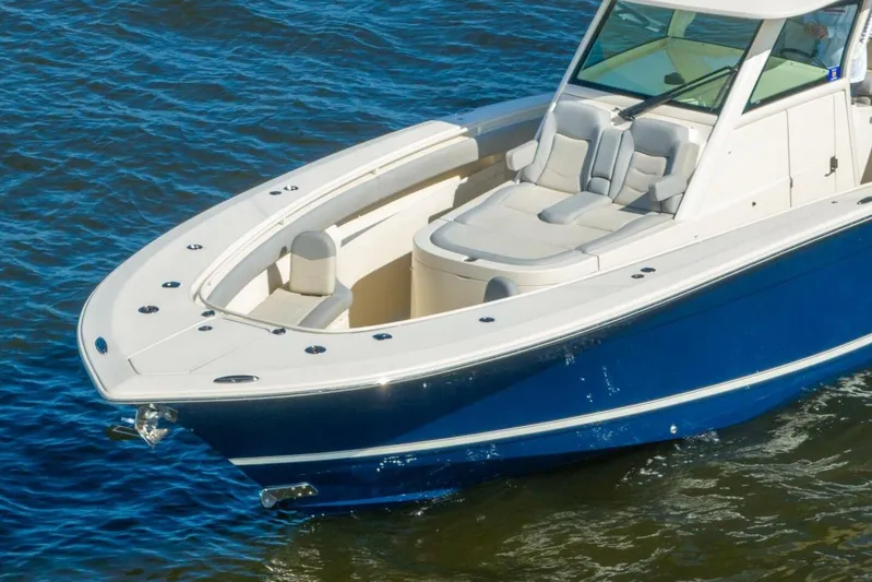  Yacht Photos Pics 2023 Scout 355 LXF boat with sleek design on blue water.