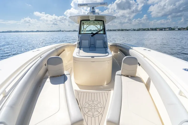  Yacht Photos Pics 2023 Scout 355 LXF boat interior with luxurious seating on a sunny day.