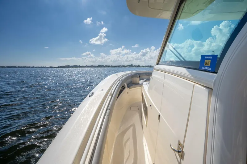  Yacht Photos Pics 2023 Scout 355 LXF boat cruising on a sunny day with clear skies.