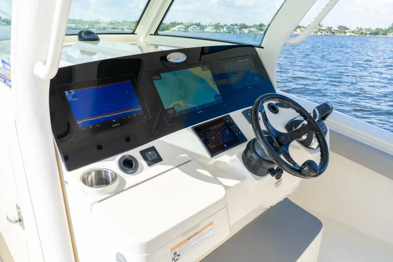  Yacht Photos Pics 2023 Scout 355 LXF boat dashboard with advanced navigation displays and steering wheel.