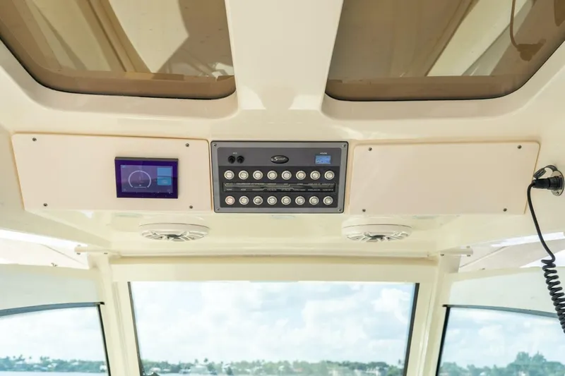  Yacht Photos Pics 2023 Scout 355 LXF boat dashboard with control panel and digital display.