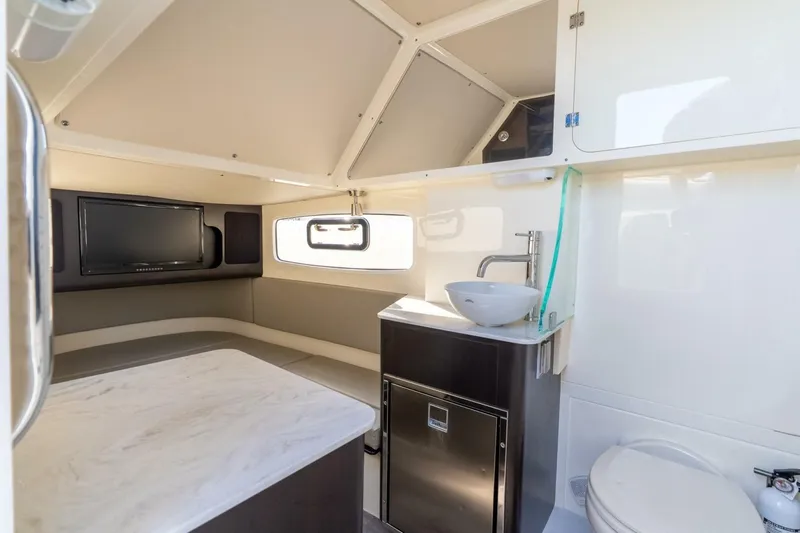  Yacht Photos Pics 2023 Scout 355 LXF cabin interior with modern amenities and sleek design.