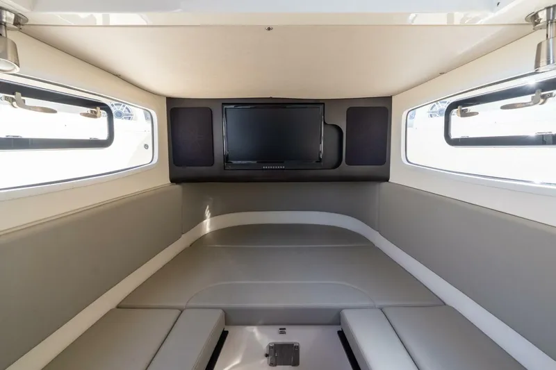  Yacht Photos Pics 2023 Scout 355 LXF cabin interior with TV and seating area.