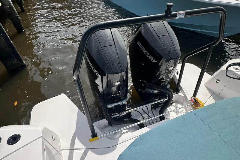  Yacht Photos Pics 2024 Axopar 37XC boat with dual Mercury outboard engines, docked in water.