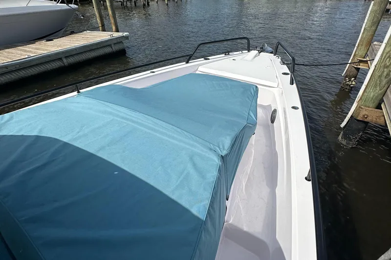  Yacht Photos Pics 2024 Axopar 37XC boat docked, featuring a blue cover and sleek design.