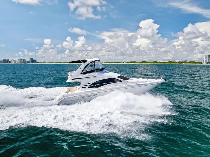 Megusta Yacht Photos Pics 2007 Sea Ray 44 Sedan Bridge yacht cruising on open water.