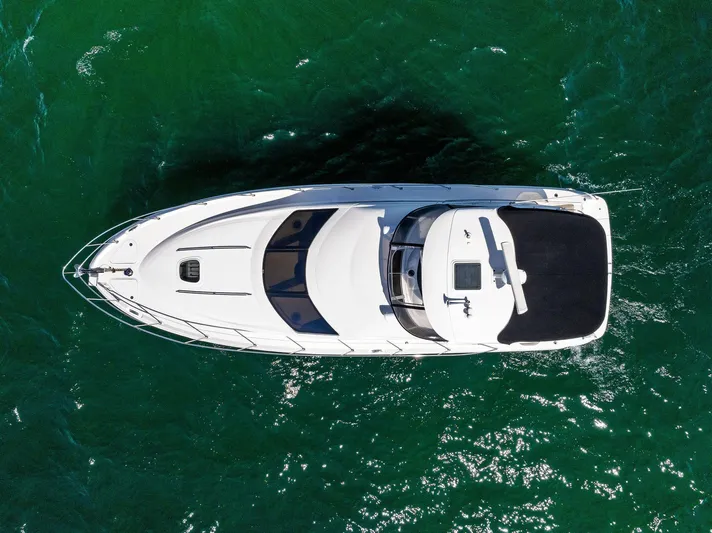 Megusta Yacht Photos Pics Aerial view of 2007 Sea Ray 44 Sedan Bridge yacht on green water.