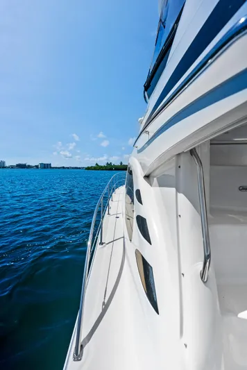 Megusta Yacht Photos Pics 2007 Sea Ray 44 Sedan Bridge yacht on open water, side view.